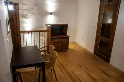 a dining room with a table and a television at Αρχοντικό Αλεξάνδρου in Kakopetria