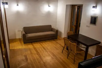 a living room with a couch and a table at Αρχοντικό Αλεξάνδρου in Kakopetria