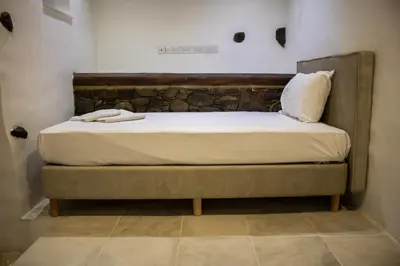 a bed with two towels on it in a room at Αρχοντικό Αλεξάνδρου in Kakopetria