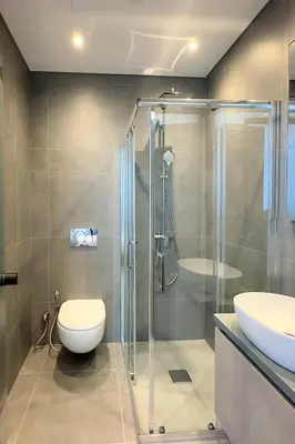 a bathroom with a shower and a toilet and a sink at Luxury Beachfront Villa - Rooftop Jacuzzi, Sunrise in Paralimni