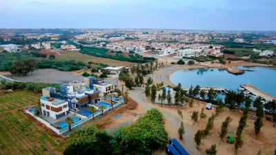 an aerial view of a resort and a lake at Luxury Beachfront Villa - Rooftop Jacuzzi, Sunrise in Paralimni