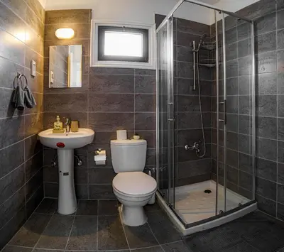 a bathroom with a toilet and a sink and a shower at Cozy Apartment In Kapparis in Paralimni