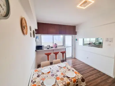 a kitchen and dining room with a table and chairs at Larnaca Garden Rooms in Larnaka
