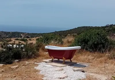 a bath tub sitting on the side of a hill at Zima Edge in Parekklisha