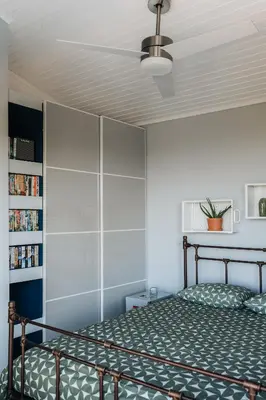 a bedroom with a bed and a ceiling fan at Zima Edge in Parekklisha