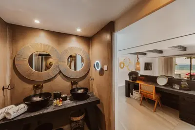 a bathroom with two sinks and mirrors on the wall at Kaliva Suites - Adults Only in Ayia Napa