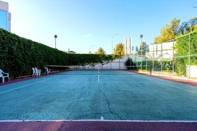 a tennis court with a net on it at Limassol Star 21 in Limassol