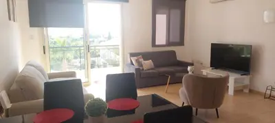 a living room with a couch and a television at Limassol Star 21 in Limassol