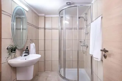 a bathroom with a sink and a shower at Quattro Beachfront Sea View Ap 206 in Larnaka