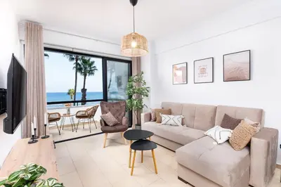 a living room with a couch and a table at Quattro Beachfront Sea View Ap 206 in Larnaka