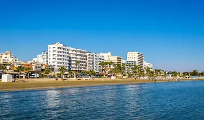 a view of a beach with buildings in the background at Quattro Beachfront Sea View Ap 206 in Larnaka