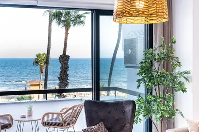 a room with a view of the ocean at Quattro Beachfront Sea View Ap 206 in Larnaka
