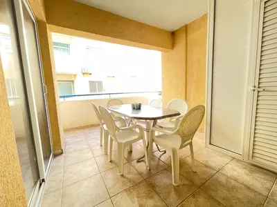 a dining room with a table and chairs and a window at Anastasia Holiday Apartment Larnaca in Larnaka