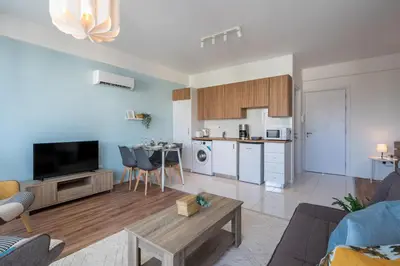 a living room with a couch and a table at Livia Studio Apartment in Larnaca in Larnaka
