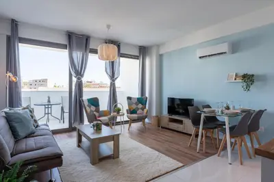 a living room with a couch and a table at Livia Studio Apartment in Larnaca in Larnaka