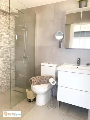a bathroom with a toilet and a shower and a sink at Sea the Sunrise in Larnaka