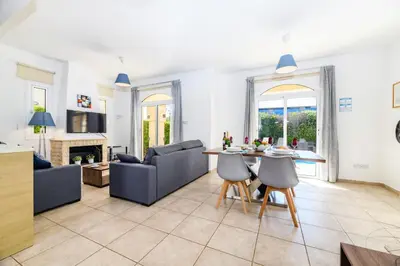 a living room with a couch and a table at Villa Oscar in Protaras
