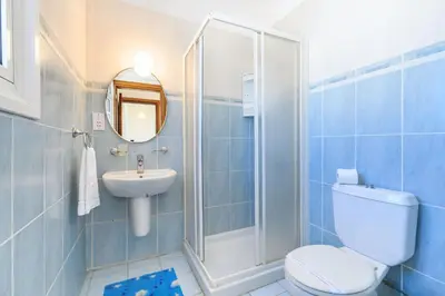 a bathroom with a toilet and a sink and a shower at Villa Oscar in Protaras