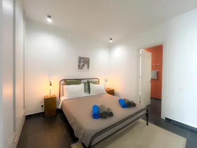 a bedroom with a bed with blue shoes on it at Bridge House 201 - 3BR Penthouse in Limassol