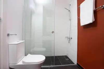 a bathroom with a toilet and a glass shower at Bridge House 201 - 3BR Penthouse in Limassol