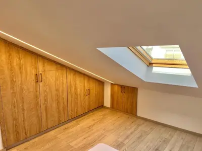 a room with wooden cabinets and a skylight at Trendy Loft Apartment in Limassol