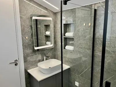 a bathroom with a sink and a mirror at Trendy Loft Apartment in Limassol