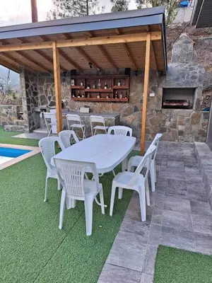 a white table and chairs on a patio with a fireplace at Marianna's House in Galata