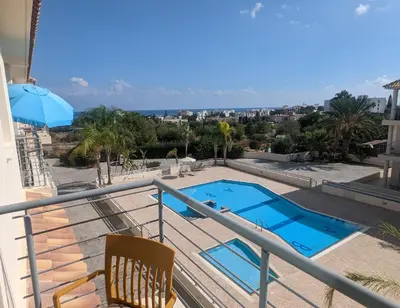 a balcony with a swimming pool on top of a building at Luxury 2-Bedroom Apt. with Seaview in Protaras