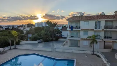 a villa with a swimming pool in front of a building at Luxury 2-Bedroom Apt. with Seaview in Protaras