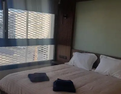 two towels on a bed in a bedroom with a window at Deluxe 1 Bed Apt Ayios Dometios in Ayios Dhometios