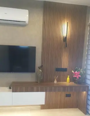 a living room with a flat screen tv on the wall at Deluxe 1 Bed Apt Ayios Dometios in Ayios Dhometios