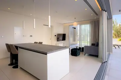 a kitchen and living room with a counter and a couch at City Napa Seaview Villas - Villa 8 in Ayia Napa