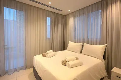 a bedroom with a large white bed with towels on it at City Napa Seaview Villas - Villa 8 in Ayia Napa