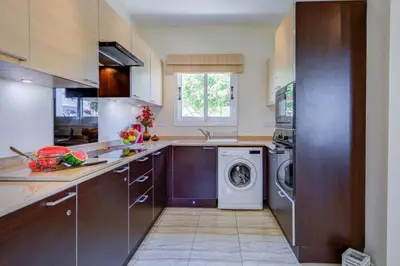 a kitchen with a washing machine and a dishwasher at Villa Niki in Ayia Napa