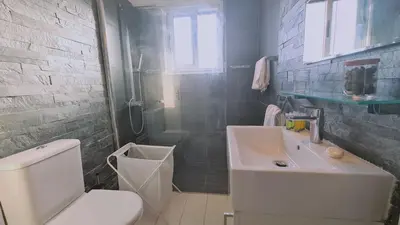 a bathroom with a white toilet and a sink at STAY Mystique Apartment in Limassol