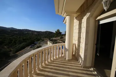 a balcony of a building with a view of a road at Villa Melyia in Kato Pyrgos