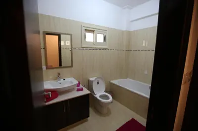 a bathroom with a sink and a toilet and a tub at Villa Melyia in Kato Pyrgos