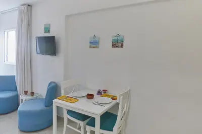 a small white table and chairs in a room at Napa Hera 's Nest in Ayia Napa