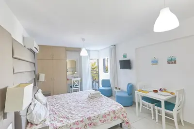 a bedroom with a bed and a table and chairs at Napa Hera 's Nest in Ayia Napa