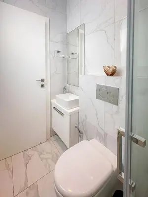 a white bathroom with a toilet and a sink at City Napa Seaview Villas - Villa 7 in Ayia Napa