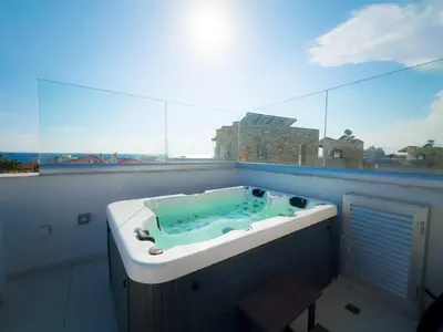 a bath tub in a room with a window at City Napa Seaview Villas - Villa 7 in Ayia Napa