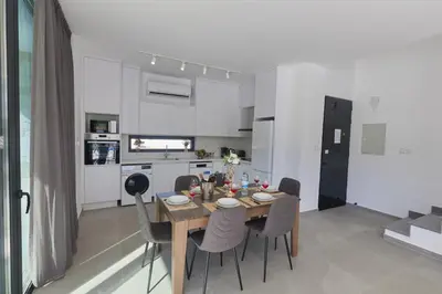 a dining room with a table and chairs in a kitchen at Protaras Elite Pearl Villa Ep4b in Protaras