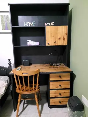 a wooden desk with a chair next to a wall at Beautiful bedroom in Limassol