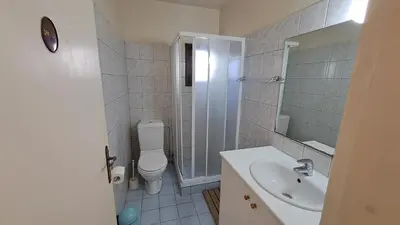 a bathroom with a toilet and a sink and a shower at Seaside 2BR Apartment 30m from Sea & Free Parking in Voroklini