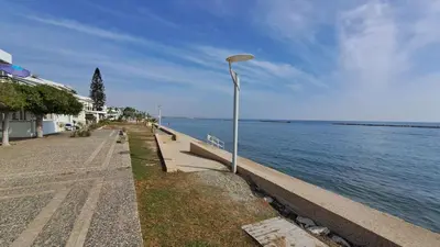 a street light next to a body of water at Seaside 2BR Apartment 30m from Sea & Free Parking in Voroklini