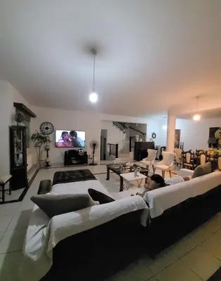 a living room with two beds and a flat screen tv at Μοναδικό δωμάτιο in Limassol