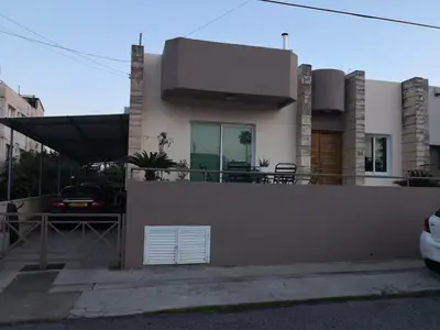 a house with a fence in front of it at Μοναδικό δωμάτιο in Limassol