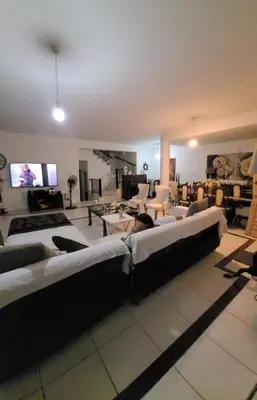 a large living room with couches and a flat screen tv at Μοναδικό δωμάτιο in Limassol