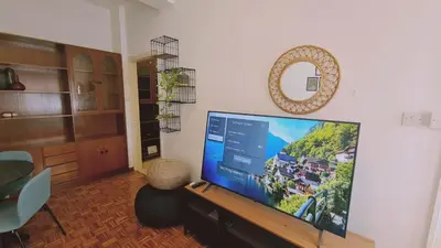 a living room with a large flat screen tv at STAY Antique Apartment in Larnaka
