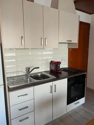 a kitchen with white cabinets and a sink and a toaster at Ellados 20 in Limassol